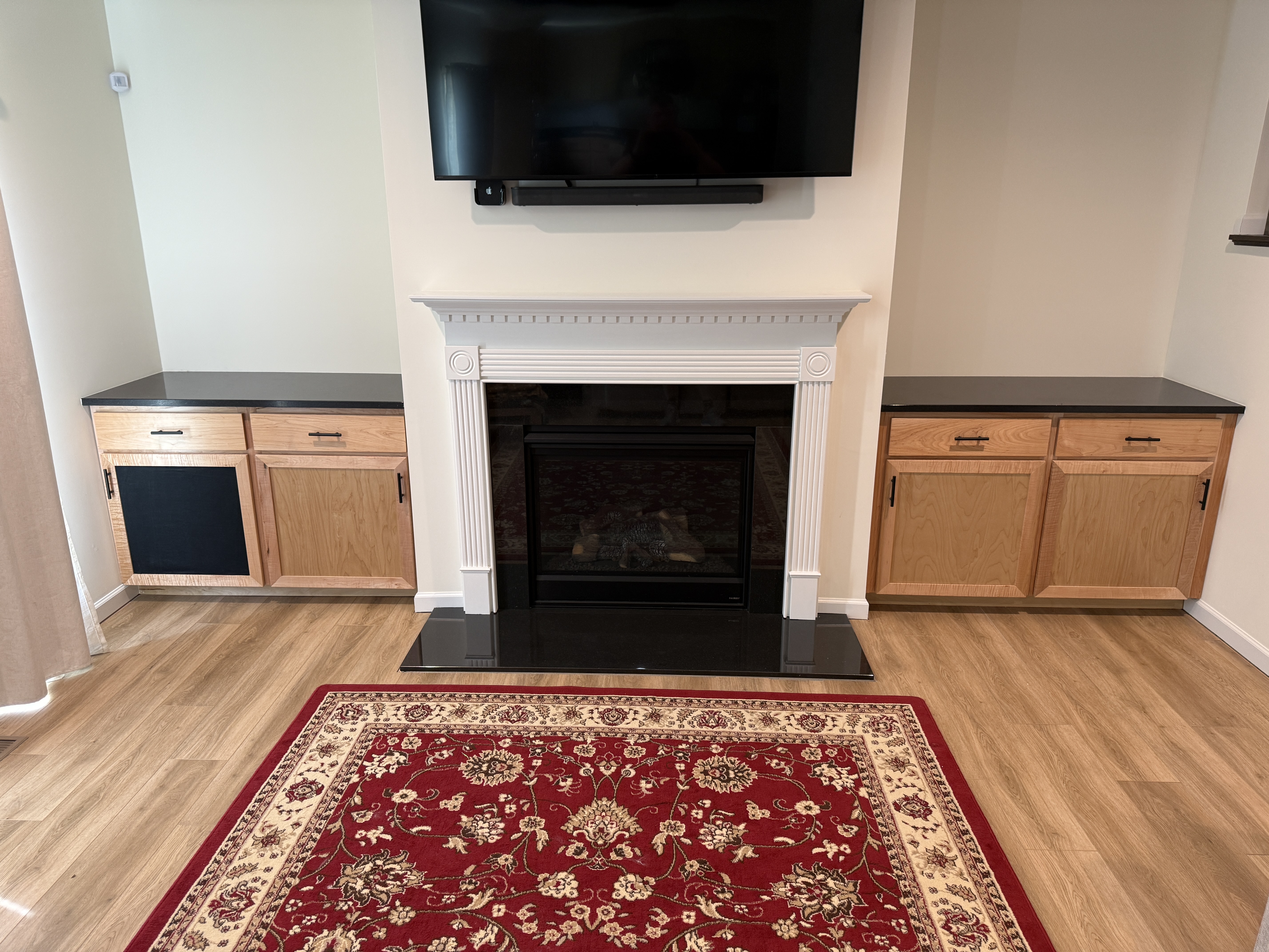 Custom natural wood cabinetry flanking a fireplace